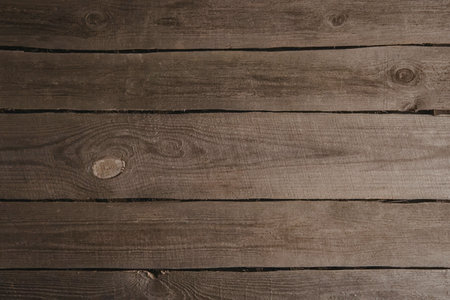 A close-up view of brown wooden planks with visible knots and grain