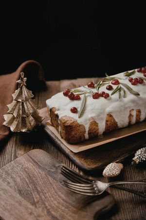 a christmas cake with white icing and red berries on top