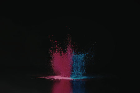 A vibrant pink and blue powder explosion against a dark background, creating a striking visual effect.の写真素材