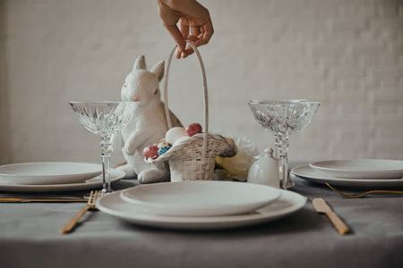 A table set for Easter with a bunny decoration and eggs