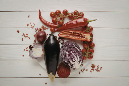 An assortment of colorful vegetables on a white wooden surfaceの写真素材