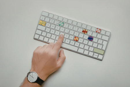A hand wearing a watch is typing on a white mechanical keyboard with colorful keys.の写真素材