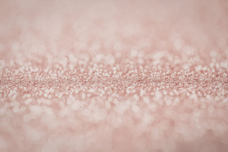A close-up of a pink glitter background texture, showcasing a sparkling and shiny surface.の写真素材