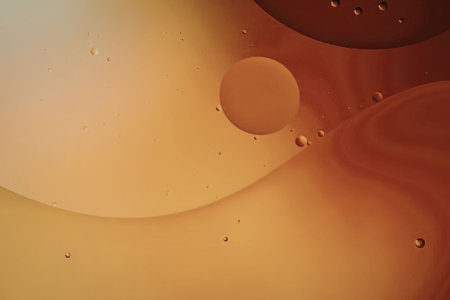 An abstract image featuring a vibrant orange gradient with bubbles of various sizes, creating a...