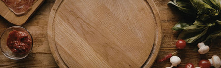 A wooden cutting board surrounded by various food ingredients such as vegetables, spices, and meats...