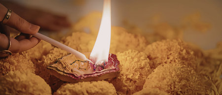 A hand lighting a traditional indian diwali lampの写真素材