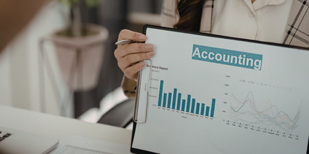 A person holding a graph related to accountingの写真素材