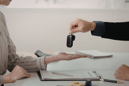 A person handing over car keysの写真素材