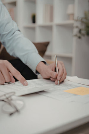 A person reviewing documents at a deskの写真素材