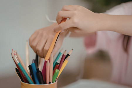 A person picking colorful pencils
