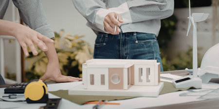 Architects working on building model