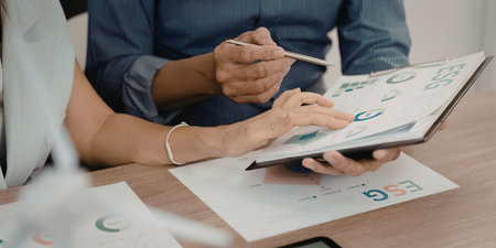 Business people reviewing documents and dataの写真素材