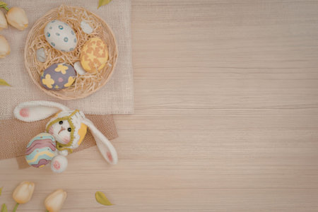 Easter eggs and bunny ears on wooden table