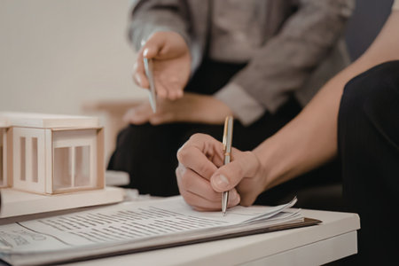 People signing documents for home purchase