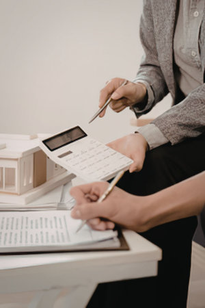 People discussing house plans with calculator