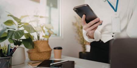 Person using phone at work desk