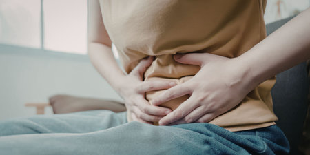 Woman experiencing abdominal pain