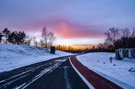 Winter scenery of the North Lake National Wetland Park in Changchun, China under the sunsetの写真素材