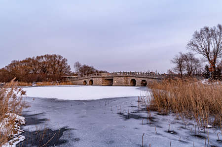Winter scenery of the North Lake National Wetland Park in Changchun, China under the sunsetの写真素材