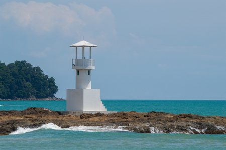 White lighthouse on a tropical beach on a gorgeous, sunny dayのeditorial素材