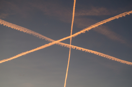 Condensation trails form unusual pattern in the skyの写真素材