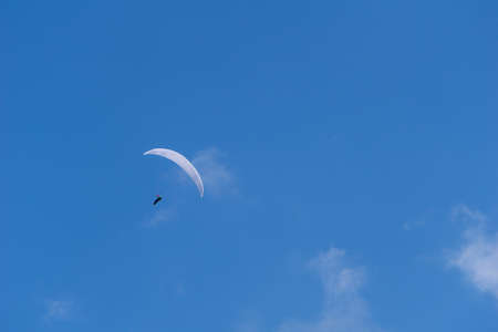 Paraglider on a blue sky backgroundの写真素材