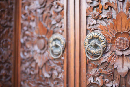 Traditional Balinese wood carved doorの写真素材