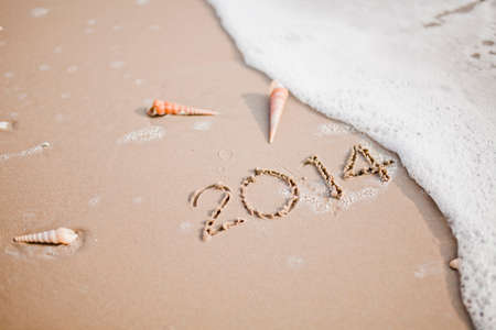 Inscription of 2014 on sand at the beachの写真素材