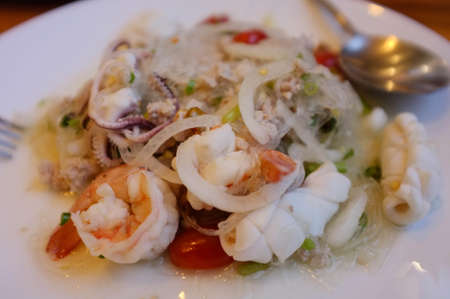 Thai vermicelli spicy salad with shrimp, squid and minced porkの写真素材