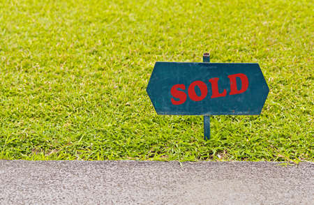 paint green on the lawn , take photographs clear shallow emphasize at the sign , の写真素材