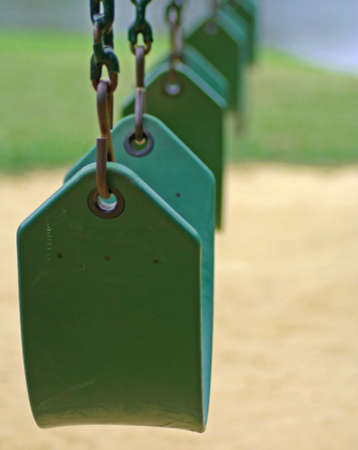 Empty swings on playgroundの写真素材