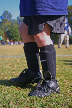 Boy's cleats and shinguards just before soccer practice