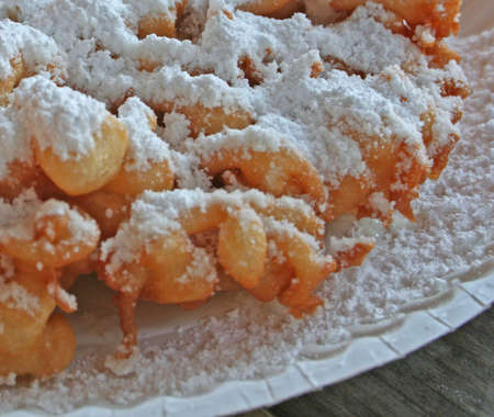 Fresh funnel cake with powdered sugar topping