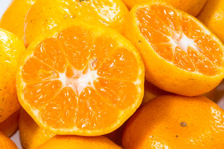 Many citrus fruit Lay heaped on a white background.の写真素材