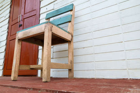 Old wooden chair in front of the house.の写真素材
