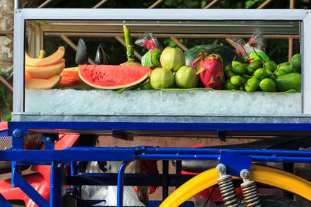 Motorcycles sell fruit, watermelon, cantaloupe, mango, guava.の写真素材