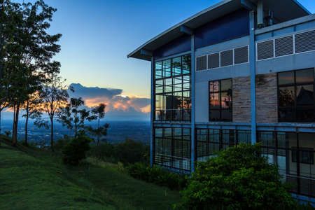 The house is on the cliff overlooking the sunset in the evening.の写真素材
