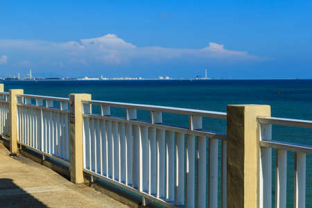 The beach has white fence, sea view.の写真素材
