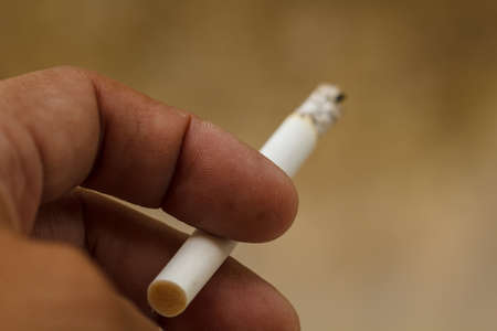 He used his index finger and middle finger  clamp cigarette.の写真素材
