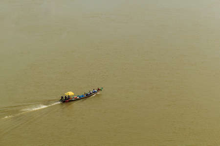 Long tail boat is running in the river with full passengers.の写真素材
