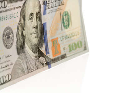 Single hundred dollars bill standing at an angle  Done on white background 