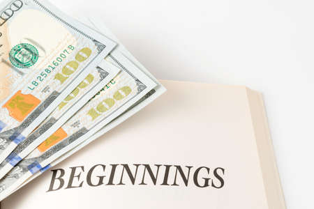 Open Book With Stack Of Hundred Dollars Bills  Beginningsの写真素材