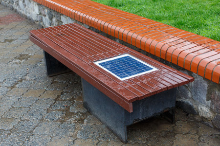 A bench with a built-in solar panel for charging phones.の写真素材