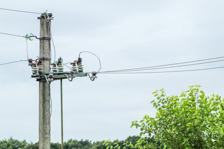 Electric power pole with wire close-up. Wire line in electrical resistance of power supply for residential buildings.の写真素材