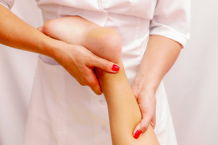 Young woman getting a massage at the spa. Body care. Therapeutic foot massage in the spa salon. Skin care, well-being.の写真素材