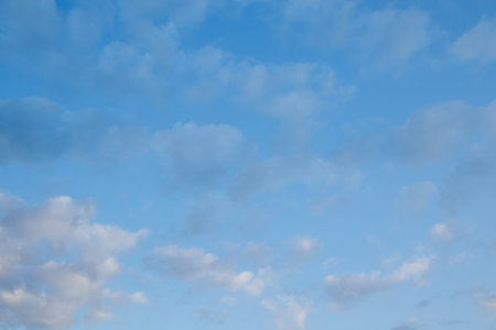 White fluffy clouds in the blue sky. Blue sky background and white clouds soft focus, pastel sky.