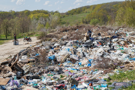 A view of the landfill. Garbage dump. A pile of plastic rubbish, food waste and other rubbish. Pollution concept. A sea of garbage starts to invade and destroy a beautiful countryside scenery.の写真素材
