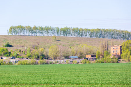 A view of the landfill. Garbage dump. A pile of plastic rubbish, food waste and other rubbish. Pollution concept. A sea of garbage starts to invade and destroy a beautiful countryside scenery.の写真素材