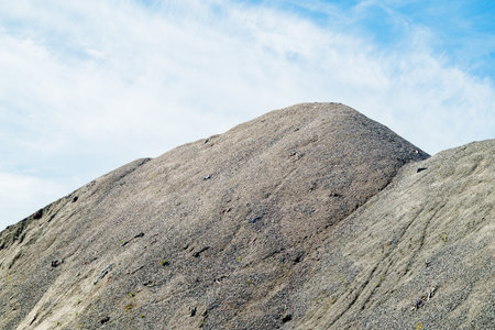 A large pile of rubble for road construction. Crushed stone for concrete mix. large piles of crushed granite or gravel in the concrete industryの写真素材