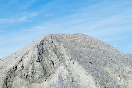 A large pile of rubble for road construction. Crushed stone for concrete mix. large piles of crushed granite or gravel in the concrete industryの写真素材